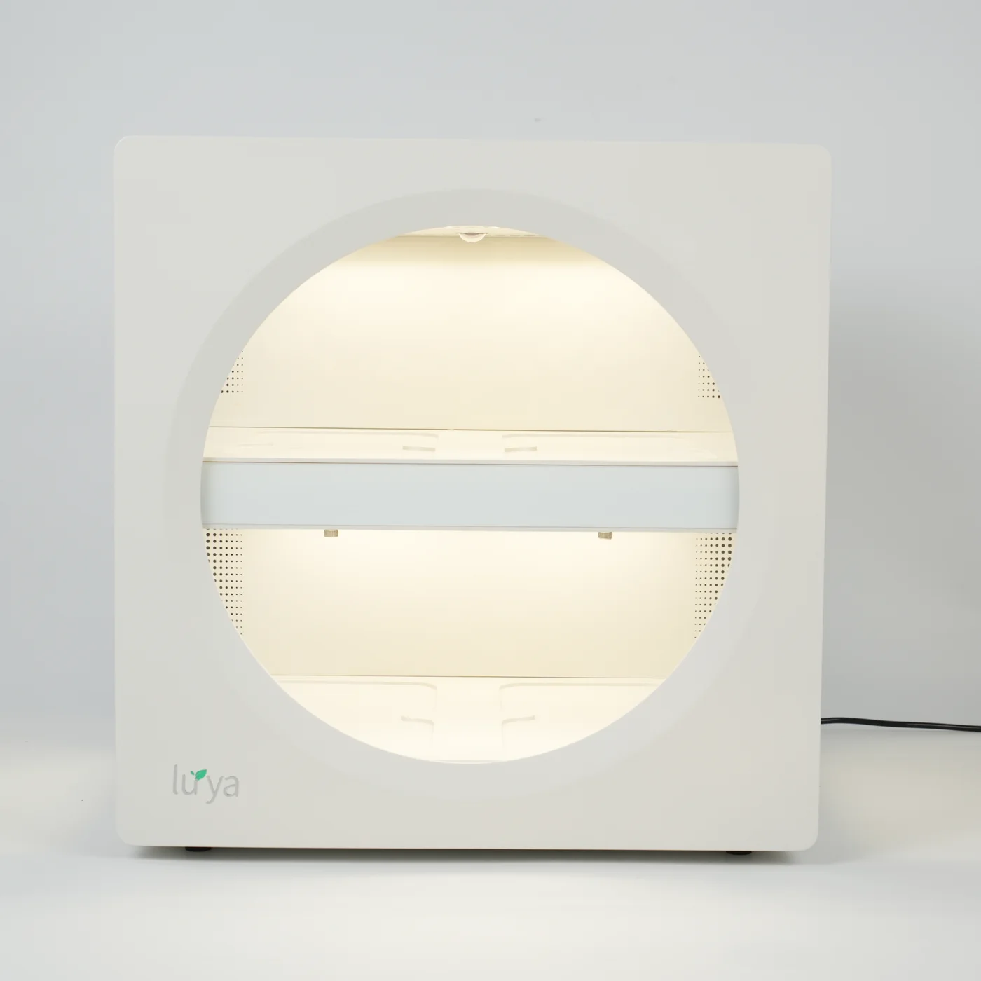 Straight-on front view of the white Luya X1, with its round window, two illuminated growing levels and central display